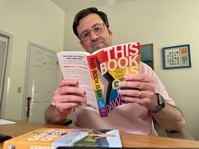 Dave is reading "This Book Is Gay."