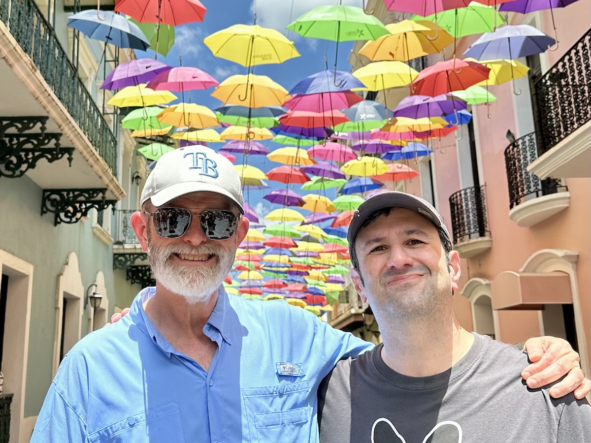 Britt and Dave on a street covered with umbrellas in San Jose, Puerto Rico